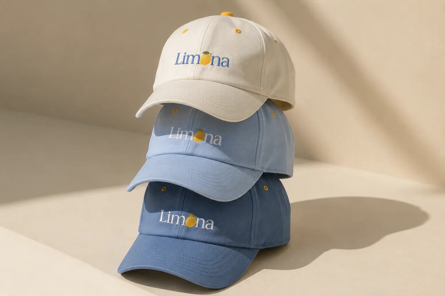 Three stacked Limona caps in beige and blue