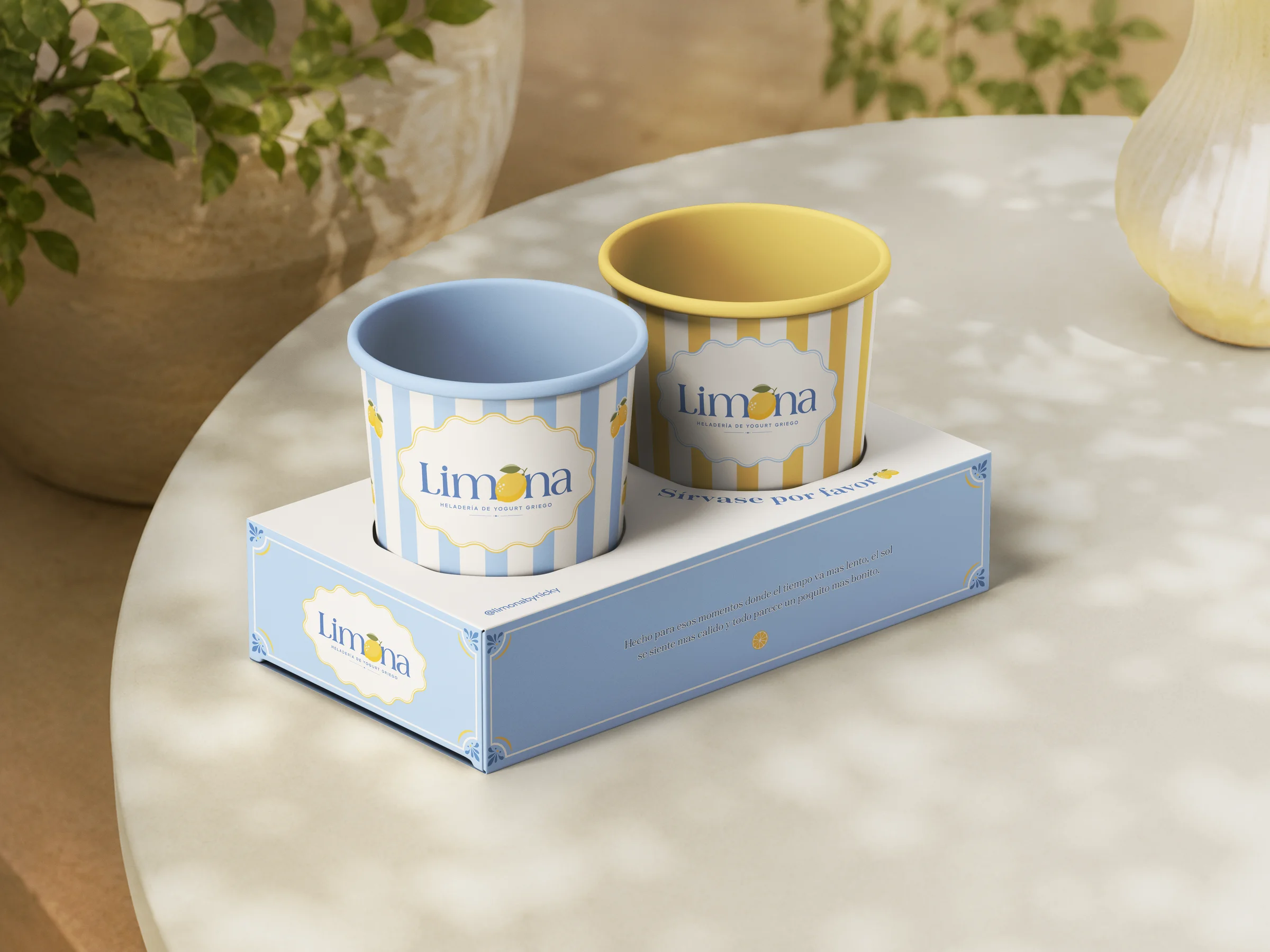 Two Limona cups in a blue striped carrier on a table