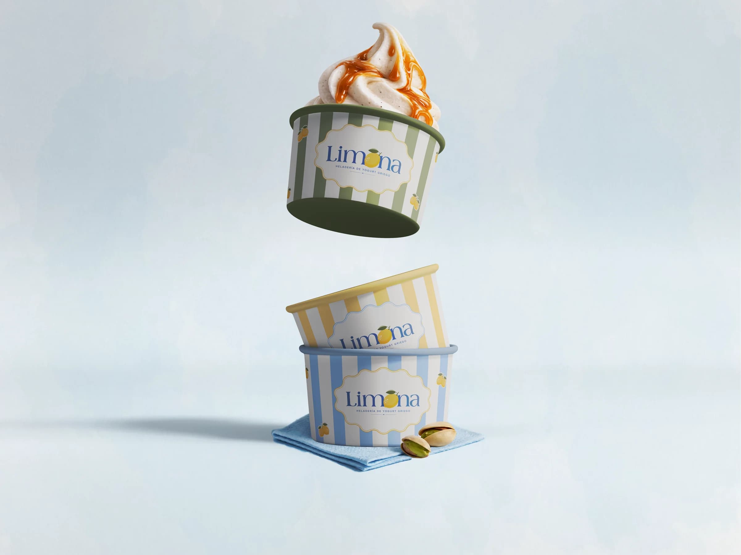 Two striped Limona cups of frozen yogurt floating