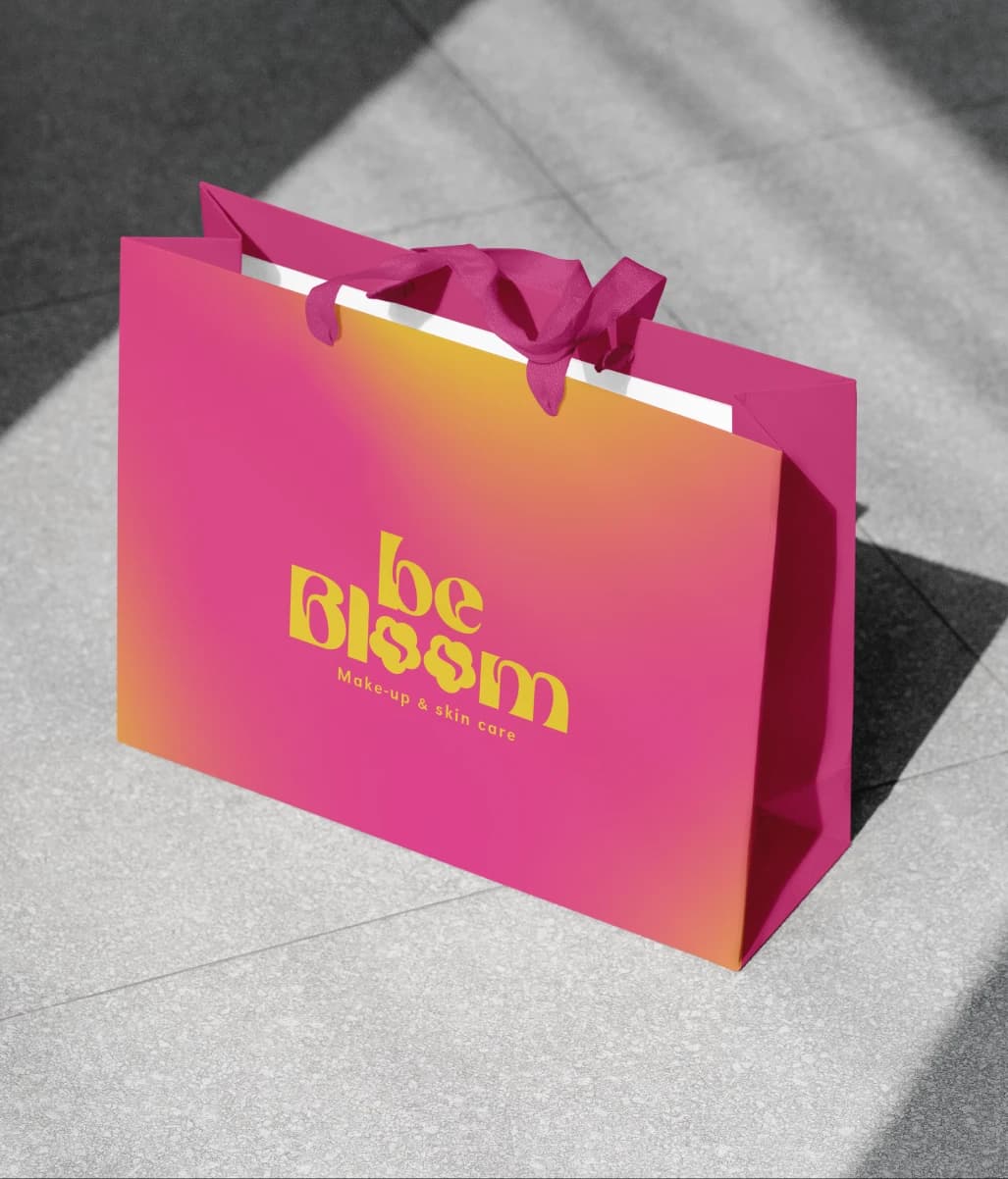 Pink and orange Be Bloom bag with a yellow logo